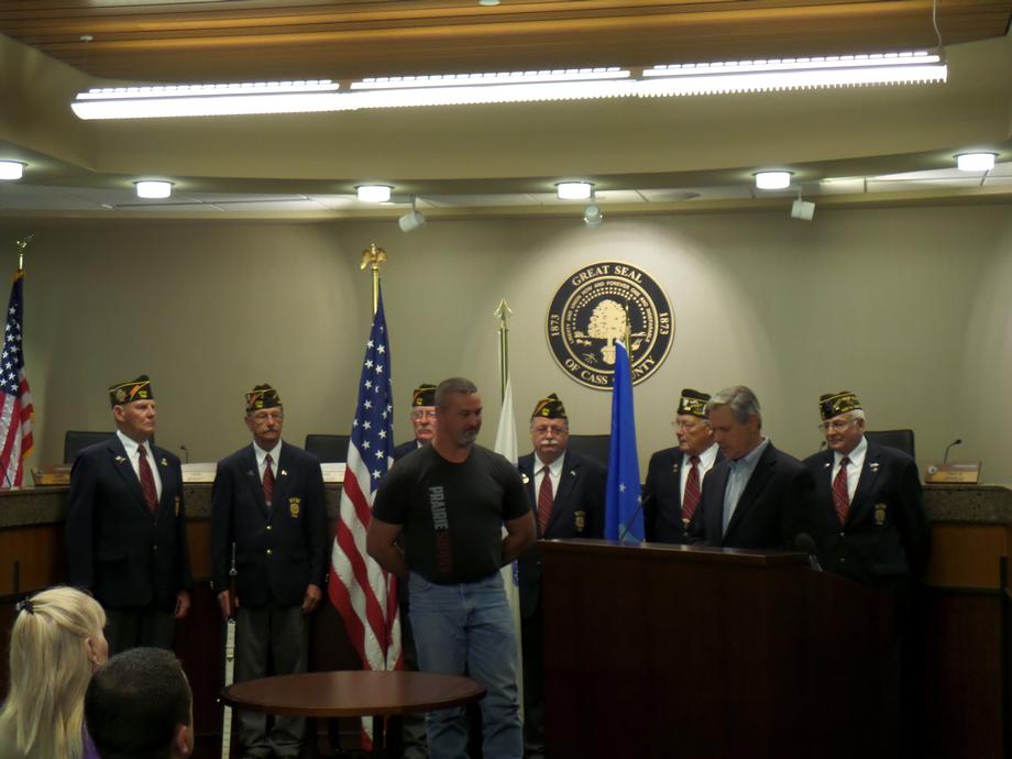 Minot Veterans Medal Presentation-August 2014- Senator Hoeven presents veteran Larry Wayman, who served with the United States Air Force in the Vietnam War, with the military medals he earned.