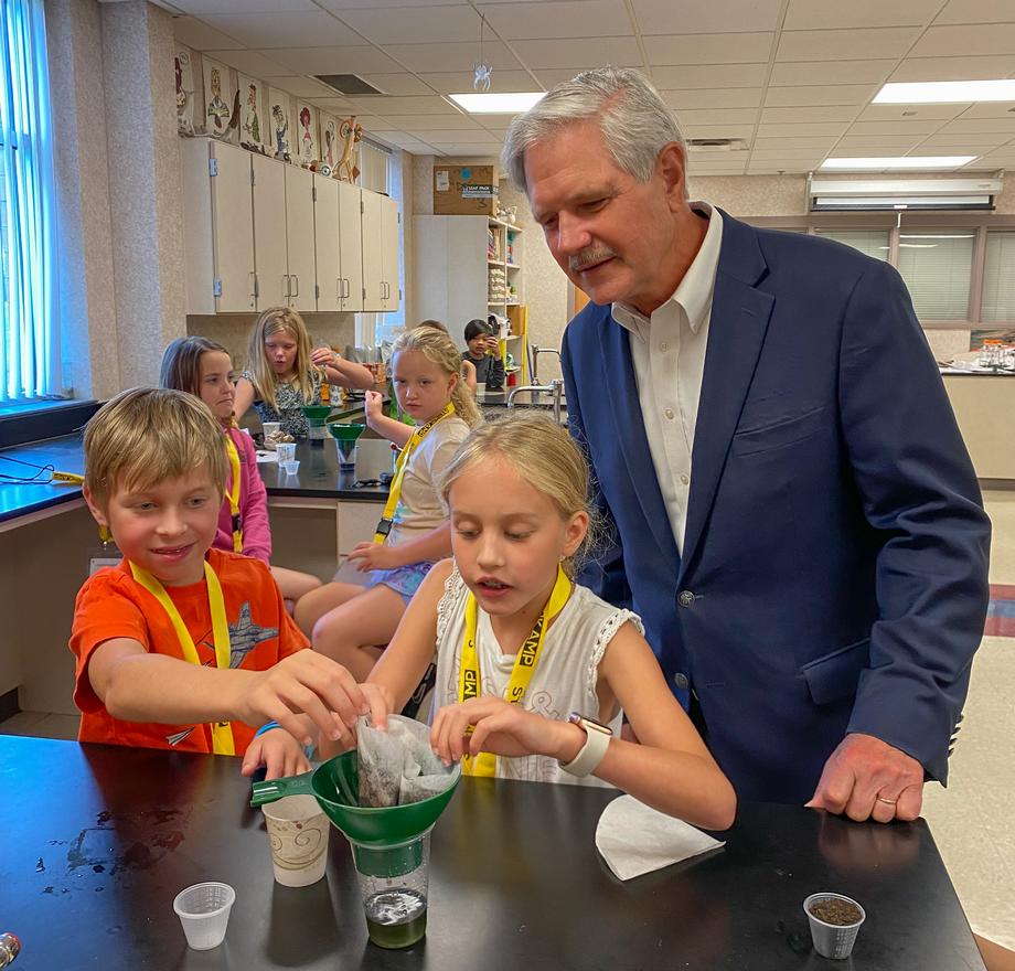 August 2022 - Senator Hoeven learns about a science project from students in Grand Forks attending STEMKAMP.