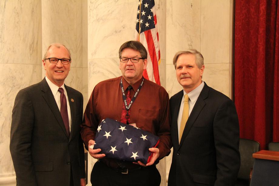 Presenting the Flag to David Michaelson-March 2015 - Senator Hoeven presents David Michaelson with a U.S. Flag in recognition of his dedicated service to students in North Dakota