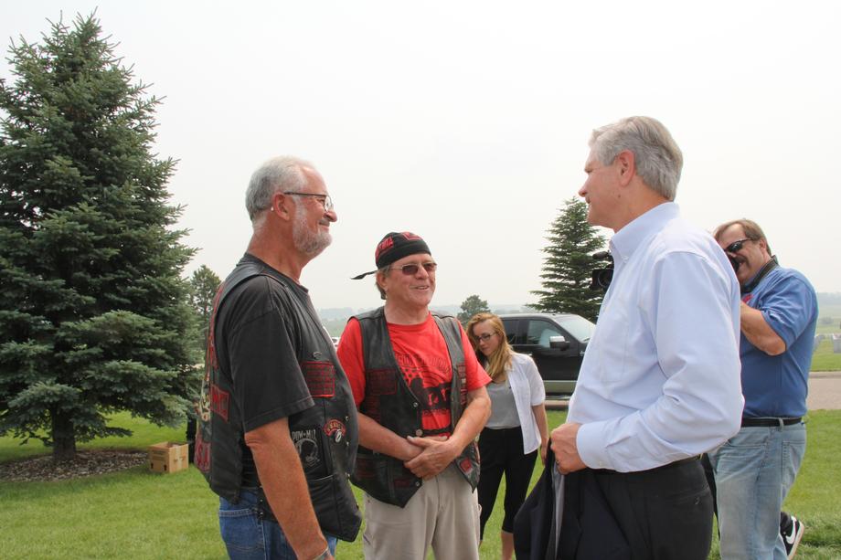 POW/MIA Memorial Dedication-July 2015 - Hoeven speaks with Virgil Horst (left) and Butch Olson (Right), members of the Viet Nam Vets Legacy Vets motorcycle club. The VNVLV and the Second Brigade Motorcycle Club worked together in creating the POW/MIA Memorial in Mandan to honor servicemembers from North Dakota who have been deemed POW or MIA. 