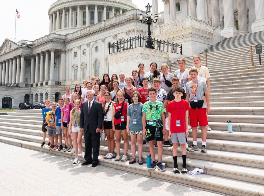 June 2022 - Senator Hoeven visits with students from Sacred Heart Middle School and Shanley High School on the steps of the Senate.